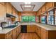 Bright kitchen featuring wooden cabinets, a skylight, and an eat-in bar with a lake view at 3865 Adams Rd, Cumming, GA 30041