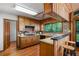 Charming kitchen with wooden cabinetry, breakfast bar, and a window showcasing the natural landscape at 3865 Adams Rd, Cumming, GA 30041