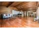 Large living room featuring hardwood floors, wood ceilings, and a bar area for entertaining guests at 3865 Adams Rd, Cumming, GA 30041