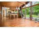 Living room with a bar and an open view to a deck area, hardwood floors and wooden ceilings at 3865 Adams Rd, Cumming, GA 30041