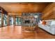 This living room offers wood ceilings, hardwood floors, a stone fireplace, and a comfortable seating area at 3865 Adams Rd, Cumming, GA 30041