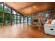 The open living room has wood ceilings, hardwood floors, a large stone fireplace, and scenic lake views at 3865 Adams Rd, Cumming, GA 30041