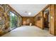 Spacious living room with stone accent wall and sliding glass door to outdoor views at 3865 Adams Rd, Cumming, GA 30041