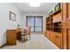 Office space featuring a built-in bookcase, desk, neutral walls, and natural light at 3865 Adams Rd, Cumming, GA 30041