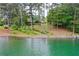 Lakefront home set among tall trees and offering a private waterfront with lake access at 3865 Adams Rd, Cumming, GA 30041