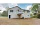View of the house and raised deck from the back with a lot of green space at 645 Woodwind Dr, Rockmart, GA 30153