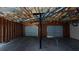 Unfinished basement with exposed insulation, utilities, and garage doors at 645 Woodwind Dr, Rockmart, GA 30153