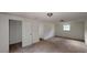Bedroom with natural lighting, carpet, two doors, and a window at 645 Woodwind Dr, Rockmart, GA 30153