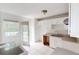 Bright kitchen features white cabinets, tile floor, and access to the backyard at 645 Woodwind Dr, Rockmart, GA 30153