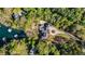 Aerial view of estate with a pool and lake access amidst lush green trees at 7305 Breeze Bay Rd, Cumming, GA 30041