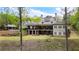 Expansive backyard with covered patio, a gazebo next to a pool, and a lush lawn at 7305 Breeze Bay Rd, Cumming, GA 30041