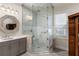 Contemporary bathroom with glass shower, gray vanity, and stylish fixtures at 7305 Breeze Bay Rd, Cumming, GA 30041