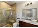 Bathroom boasts a tiled glass shower, granite counters, and wood vanity at 7305 Breeze Bay Rd, Cumming, GA 30041