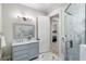 Bathroom with glass enclosed shower, gray vanity, and marble floors at 7305 Breeze Bay Rd, Cumming, GA 30041