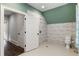 Modern bath displaying white-tiled walls, a sleek shower, and stylish fixtures for a clean design at 7305 Breeze Bay Rd, Cumming, GA 30041