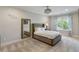 Bright bedroom with large window, plush carpeting, and elegant furnishings at 7305 Breeze Bay Rd, Cumming, GA 30041