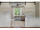 Comfortable bedroom with sliding barn doors at 7305 Breeze Bay Rd, Cumming, GA 30041
