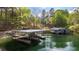Modern boat dock with covered boat storage and two boats parked side by side at 7305 Breeze Bay Rd, Cumming, GA 30041