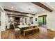 Open dining room features wood beams, hardwood floors, and access to outdoor space at 7305 Breeze Bay Rd, Cumming, GA 30041