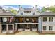 Beautiful view of the expansive outdoor living space, with covered patios and a manicured lawn at 7305 Breeze Bay Rd, Cumming, GA 30041