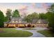 Beautiful house with a circular driveway and meticulous landscaping surrounded by trees at 7305 Breeze Bay Rd, Cumming, GA 30041