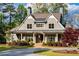 Stunning craftsman home featuring a well-manicured lawn and a circular driveway for enhanced curb appeal at 7305 Breeze Bay Rd, Cumming, GA 30041