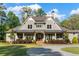 Beautiful exterior showcasing lush landscaping and a winding drive adding to the property's elegance at 7305 Breeze Bay Rd, Cumming, GA 30041
