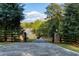 Elegant gated entrance providing privacy and security with lush landscaping surrounding the property at 7305 Breeze Bay Rd, Cumming, GA 30041