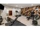 Well-equipped home gym with wood accent wall and barn doors leading to sauna at 7305 Breeze Bay Rd, Cumming, GA 30041
