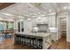 Bright kitchen showcasing an island with bar stools, pantry, modern appliances and view to dining area at 7305 Breeze Bay Rd, Cumming, GA 30041