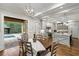 Spacious kitchen flows to the dining area and an outdoor pool for seamless indoor-outdoor living at 7305 Breeze Bay Rd, Cumming, GA 30041