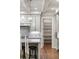 Kitchen featuring an island with bar stools, granite countertops, and a walk-in pantry at 7305 Breeze Bay Rd, Cumming, GA 30041