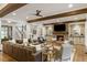 Comfortable living room with hardwood floors, a fireplace, built-in cabinets, and staircase leading to the upper level at 7305 Breeze Bay Rd, Cumming, GA 30041