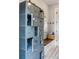 Locker room area with bench, vintage lockers, and a round window at 7305 Breeze Bay Rd, Cumming, GA 30041