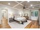 Spacious main bedroom with coffered ceilings, hardwood floors, and lots of light at 7305 Breeze Bay Rd, Cumming, GA 30041