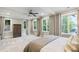 Main bedroom with large windows and neutral tones to bring the outdoors in at 7305 Breeze Bay Rd, Cumming, GA 30041