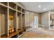 Well-organized mudroom with custom built-ins, bench and herringbone brick floors at 7305 Breeze Bay Rd, Cumming, GA 30041