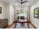 Bright office with hardwood floors, large windows, and classic wooden desk at 7305 Breeze Bay Rd, Cumming, GA 30041