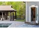 Beautiful outdoor space with a covered patio, pool, and bath house with lockers at 7305 Breeze Bay Rd, Cumming, GA 30041