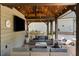 Charming pool house with outdoor seating, a ceiling fan, and decorative lights creating a cozy and inviting space at 7305 Breeze Bay Rd, Cumming, GA 30041