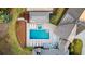 Aerial shot of pool and patio with a hot tub and lounge chairs for relaxation at 7305 Breeze Bay Rd, Cumming, GA 30041