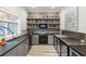 Elegant poolside bar featuring black countertops, gray cabinets, and plentiful beverage storage at 7305 Breeze Bay Rd, Cumming, GA 30041