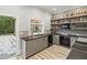 Stylish poolside bar with gray cabinetry, modern appliances, and well-stocked shelves at 7305 Breeze Bay Rd, Cumming, GA 30041