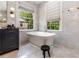 Elegant bathroom featuring a freestanding tub, black vanity, modern fixtures, and natural light at 808 Lullwater Ne Rd, Atlanta, GA 30307