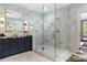 Luxurious bathroom featuring a glass-enclosed shower, marble tile, and a double vanity with modern fixtures at 808 Lullwater Ne Rd, Atlanta, GA 30307
