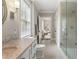 Elegant bathroom featuring a glass shower, marble countertop, and a calming neutral color scheme at 808 Lullwater Ne Rd, Atlanta, GA 30307