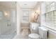 Bathroom showcases a glass shower, toilet, and marble countertop sink at 808 Lullwater Ne Rd, Atlanta, GA 30307