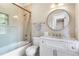 Bright bathroom features a bathtub, glass shower, vanity with marble countertop, and ample natural light at 808 Lullwater Ne Rd, Atlanta, GA 30307
