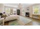 Sun-filled bedroom with a modern light fixture, hardwood floors, and neutral decor at 808 Lullwater Ne Rd, Atlanta, GA 30307