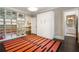 The bedroom features a built-in shelving unit, Murphy bed, and a colorful accent rug that adds character to the room at 808 Lullwater Ne Rd, Atlanta, GA 30307